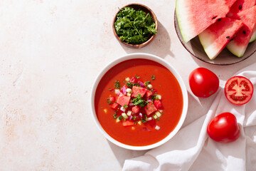 Spanish tomato and watermelon gazpacho cold soup styled and decorated in white plate