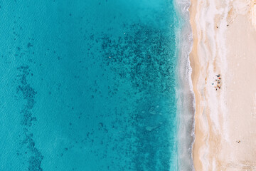 aerial view showcases a breathtaking beach paradise, inviting viewers to embark on a dreamy vacation escape. From above, the scene reveals a pristine expanse of golden sand meeting turquoise waters.