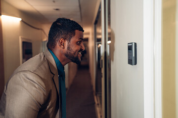 Businessman using face scanner to unlock door in office, Biometric admittance control device for security system.