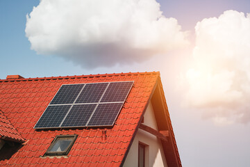 Modern black cells solar panels on the roof of private house. Photovoltaic dotation from European...