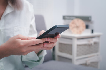 Close up Woman hands holding smartphone, using online app and virtual services cellphone, making video phone call, texting and chatting on messengers, buying online, articles.