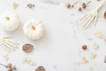 white halloween pumpkins with decor on marble background