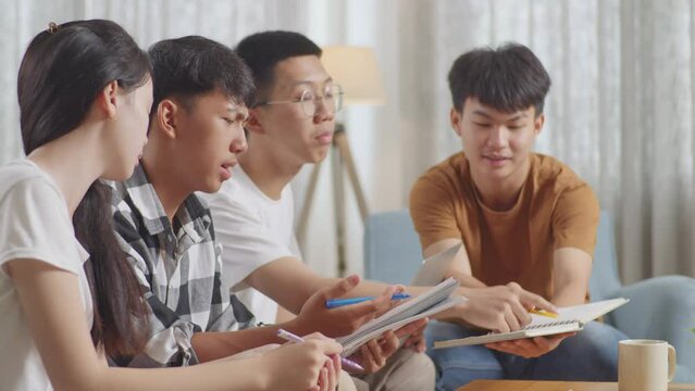 Close Up Of Asian Teen Group Studying At Home. Group With A Laptop And Books In Conflict Arguing And Trying To Blame Each Other 
