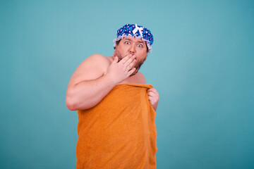 Funny fat man is washing himself in the shower.