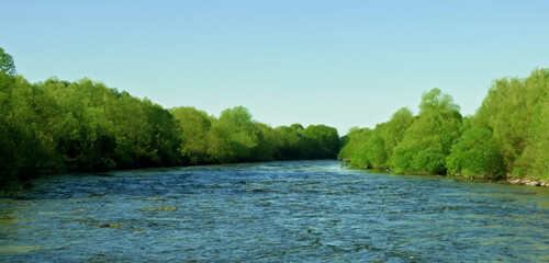 wide river Surrounded by the nature of green trees and rivers during the day