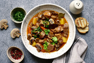 Meat stew ( beef bourguignon ) with vegetable and mushrooms. Top view with copy space. - obrazy, fototapety, plakaty