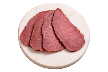 Beef jerky pieces isolated on white background. Sliced pieces of dry meat on a stone floor. close up