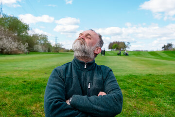 Pompous pensioner resting and sitting at public park in England