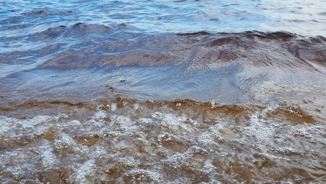 Recreational water movement. Lake Losossinnoe, Karelia. Waves, ripples, fluctuation of the surface of a lake, sea, ocean under the influence of wind. Water with high content of dissolved iron. Tourism