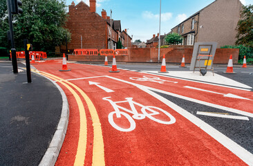 New cycling path made of red asphalt as part of 10 minutes city development plan.