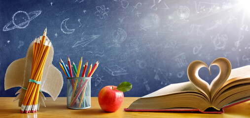 Back To School - Book With Rocket And Colorful Pencils On Desk With Blackboard - Startup Concept