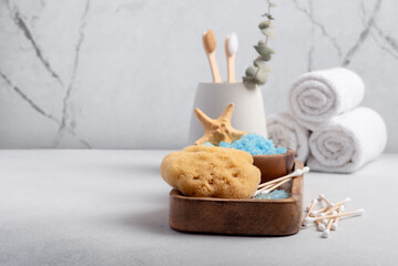 Bath Spa Setting with blue sea salt, natural sponge and bamboo toothbrushes