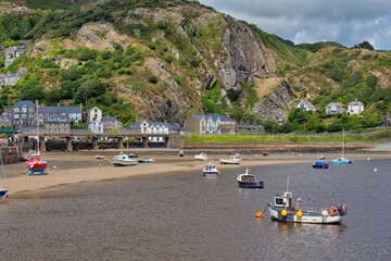 boats on the shore and town with mountains