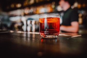 Cocktail Negroni with gin, campari martini rosso and orange. negroni cocktail in bar