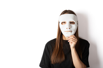 young woman wearing a white theatrical mask on her face, copy space