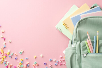 A vibrant back-to-school setup awaits. Top view of sage backpack full of stationery, copybooks,...