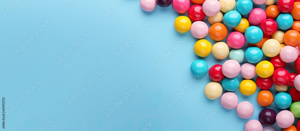 Poster colorful candy balls are displayed on a blue paper background in the format of a horizontal