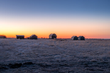Fototapeta premium Sunrise over rustic farm buildings Keoma Alberta Canada