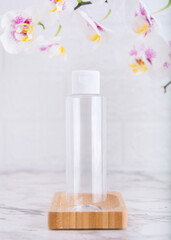 Fototapeta na wymiar Transparent cosmetic plastic bottle with flip top cap. Bottle for cosmetics and medical products.