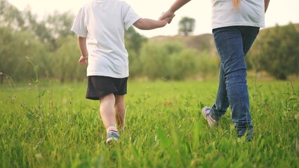 children park. little brother and sister are walking in the park with a dog. kids park family concept. children run on the grass with their pet, have fun. spring mood, peaceful lifestyle atmosphere