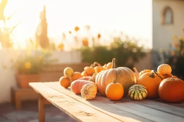  Decorative striped pumpkins on a wooden table on sunny autumn day. Thanksgiving decoration outdoors. Celebrating traditional autumn holidays. © MNStudio