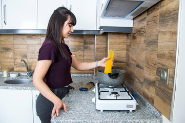 beautiful woman cooking pasta in the kitchen