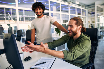 Men freelancers in a coworking office at a computer working