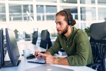 A man working as a call center operator in an office
