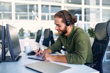 A man working as a call center operator in an office