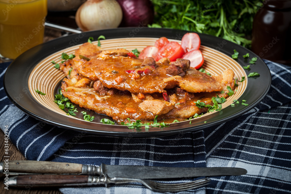 Poster potato pancakes with meat, vegetable, tomato and parsley.