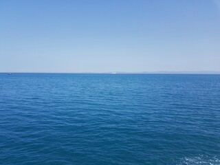 The front view in the morning sky is bright blue with clear white clouds. And the deep indigo of the ocean in broad daylight feeling calm, fresh, relaxing. Gibraltar from Belyounech city in Morocco.
