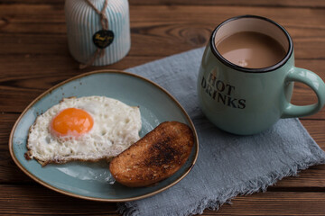fried eggs with white toast and cherry jam. Breakfast with a cup of fragrant coffee