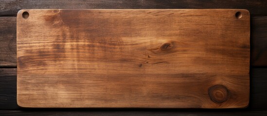 old cutting board on a dark wooden table. The view is from above and space available for copying. - Powered by Adobe