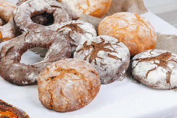 Different types of artisan craft bread in bakery store shelves