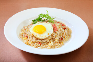 delicious ham chicken, egg, fried rice in white plate on brown background premium western cafe halal food menu for restaurant