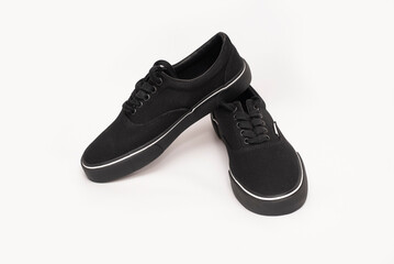 Black sneakers for men, boys on a light background, sports elegant shoes made of fabric and with a durable rubber sole