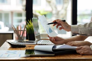 Financier or Analyst Colleagues Discussing a New project Opportunity, Talking in an Office Meeting Room. Close Up of a Tablet Computer with Project Planning and Development Timeline