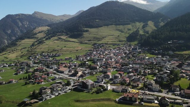 South Tirol village embedded in green mountain landscape from top