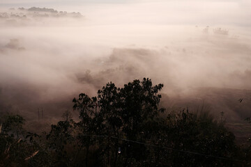 Beautiful Sunset and sunrise on sky and golden twilight time with mist and fog in valley of layer mountain