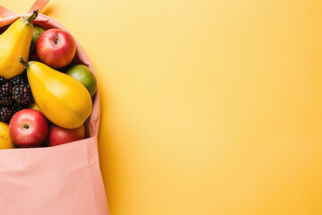 Top view of paper kraft bag with different fresh tropical fruits isolated on flat yellow background...