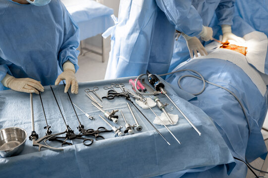 Surgery treatment in progress, close-up on table with medical tools. Concept of real invasive surgery in operating room