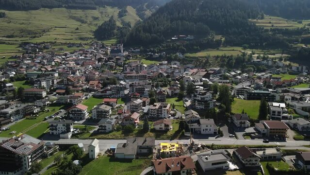 South Tirol village embedded in green mountain landscape from top