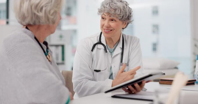 Senior doctor, tablet and discussion with patient for healthcare prescription or diagnosis at hospital. Mature medical professional talking to elderly female person on technology for consultation