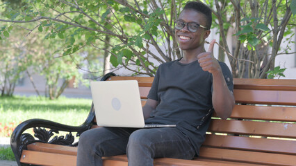 Fototapeta premium Thumbs Up by Young African Man on Laptop Outdoor
