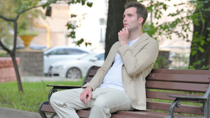 Fototapeta premium Brainstorming Casual Young Man Sitting Outdoor