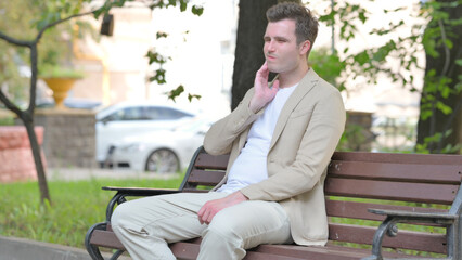 Fototapeta premium Casual Young Man with Toothache Sitting Outdoor