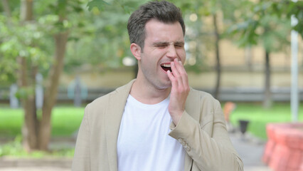 Outdoor Portrait of Yawning Casual Young Man