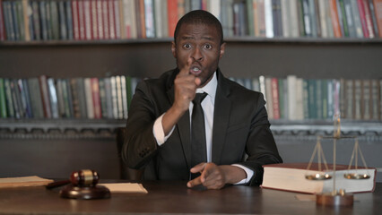 Upset African Male Lawyer Arguing during Video Chat in Office