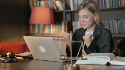 Excited Female Lawyer Celebrating Success on Laptop