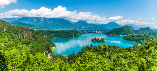 A panorama view from the Ojstrica viewpoint over Lake Bled and the village of Bled, Slovenia in summertime